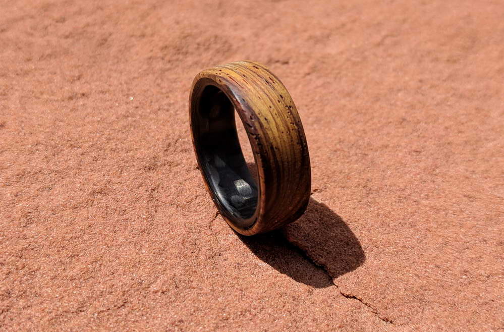 cocobolo ring with carbon fiber sleeve on red rocks