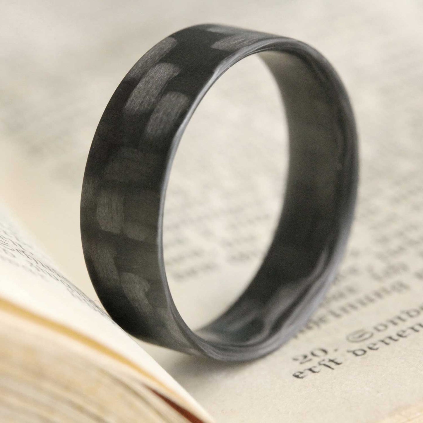 Carbon Fiber Ultralight Ring In An Open Book