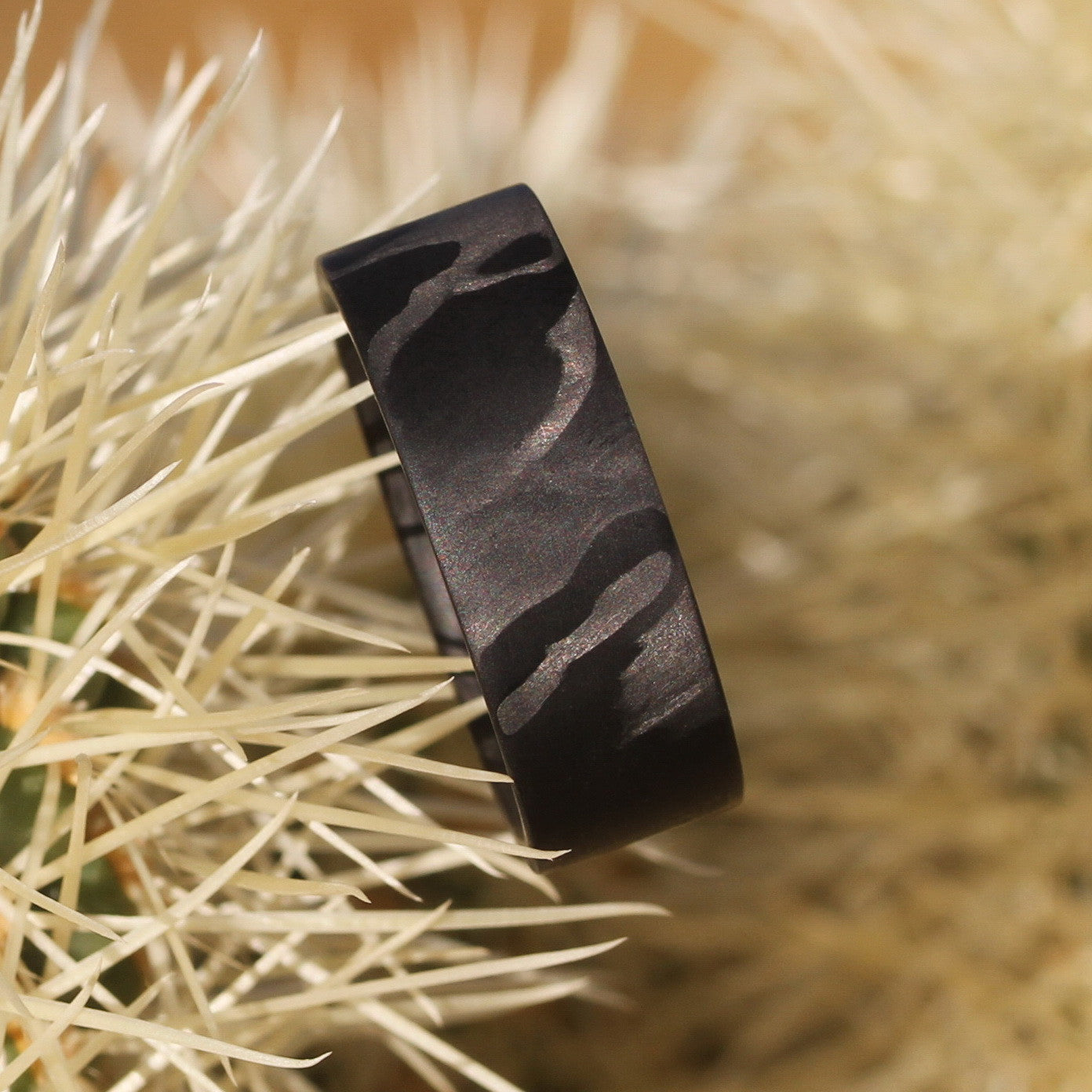 men's carbon fiber wedding ring in a cactus