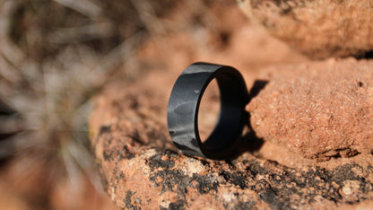 men's carbon fiber wedding ring on the red rocks of the desert