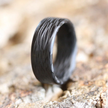 Men's Carbon Fiber Wedding Band On The Ground