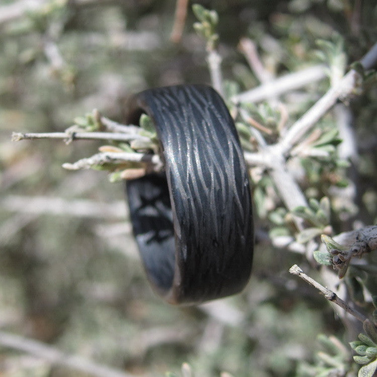 Men's Carbon Fiber Wedding Band Held By A Twig